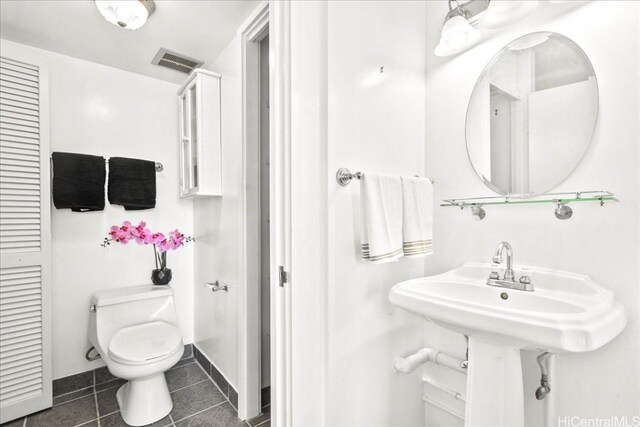 bathroom featuring tile patterned floors and toilet