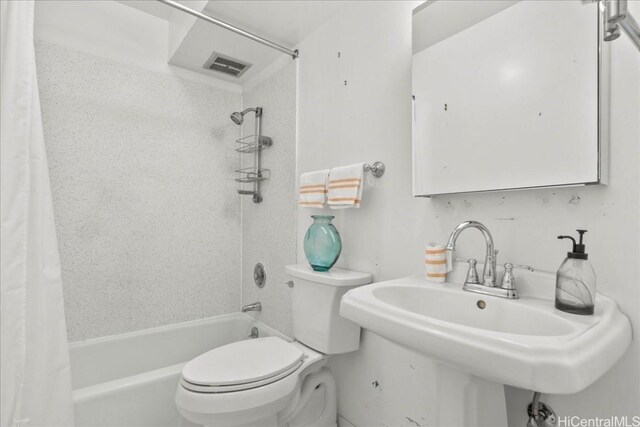 full bathroom with sink, toilet, and shower / tub combo with curtain