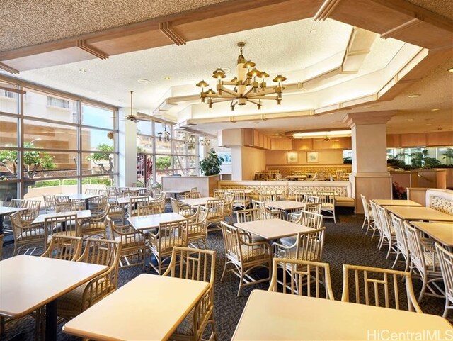 410 Atkinson Dr Unit 932, Honolulu, HI 96814 - dining room with a textured ceiling, a raised ceiling, and a chandelier