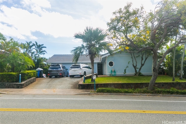 view of front of home featuring a garage and a front lawn