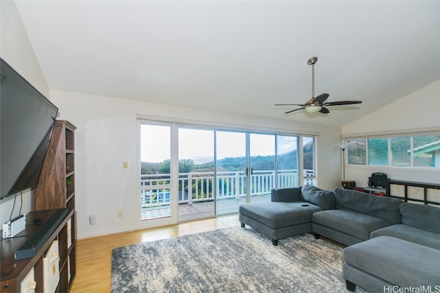 living room featuring light wood-type flooring, ceiling fan, and lofted ceiling