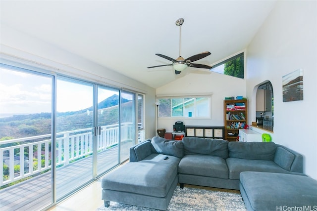 living room featuring vaulted ceiling, a wealth of natural light, and ceiling fan