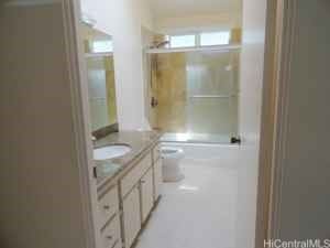 bathroom featuring vanity, an enclosed shower, and toilet