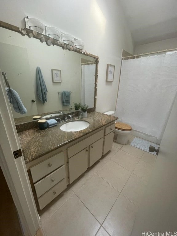 bathroom with tile patterned flooring, vanity, and toilet