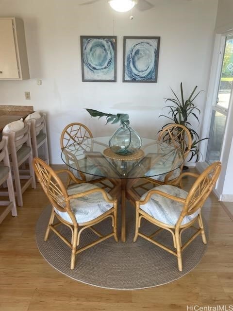 dining room with ceiling fan and light wood-type flooring