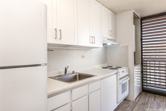 kitchen with light hardwood / wood-style flooring, sink, white cabinets, a textured ceiling, and white appliances