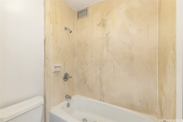 bathroom with toilet, a textured ceiling, and  shower combination