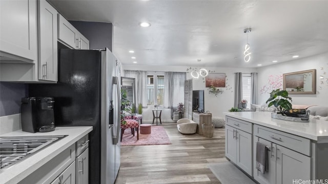 kitchen with light hardwood / wood-style flooring, decorative light fixtures, and gray cabinets