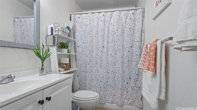 bathroom featuring vanity, toilet, and a shower with shower curtain