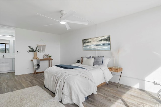 bedroom with ceiling fan, light hardwood / wood-style floors, and ensuite bath