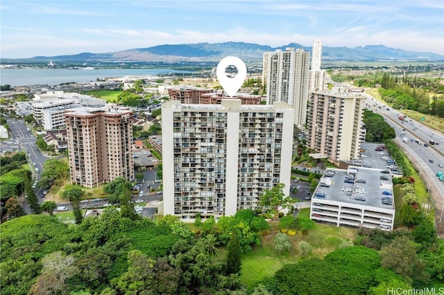 birds eye view of property with a water and mountain view