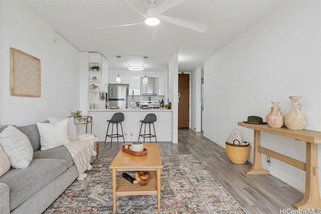 living room with ceiling fan and hardwood / wood-style floors