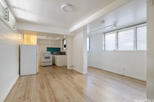 kitchen with brick wall, light hardwood / wood-style floors, white cabinetry, and white appliances