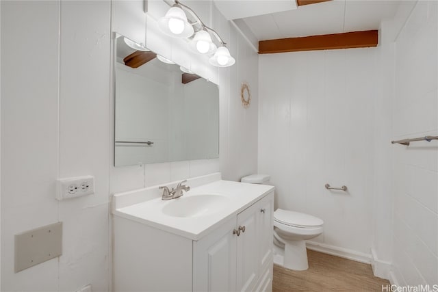 bathroom featuring hardwood / wood-style floors, vanity, and toilet