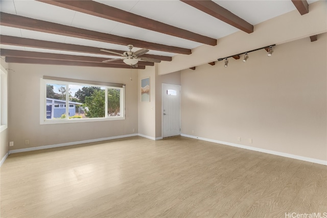 empty room with ceiling fan, light hardwood / wood-style floors, and lofted ceiling with beams