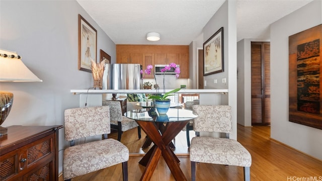 sitting room with light hardwood / wood-style floors and a textured ceiling