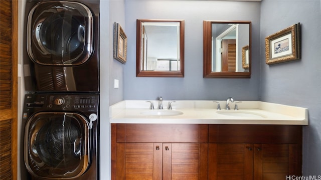 bathroom with dual sinks and stacked washer / dryer