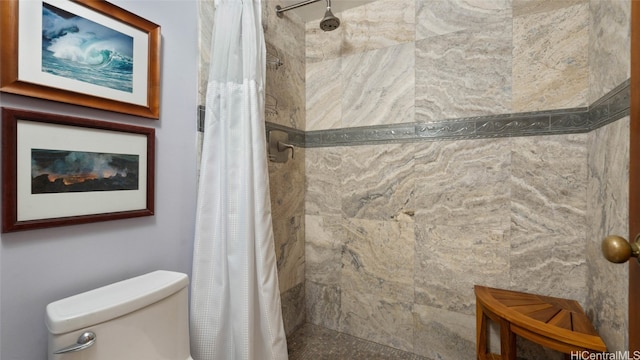 bathroom with a shower with shower curtain and toilet