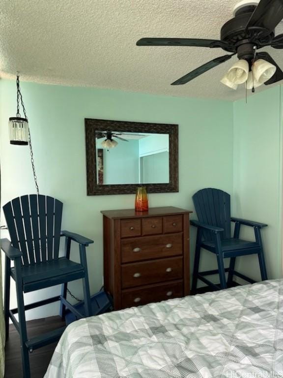 bedroom with a textured ceiling and ceiling fan