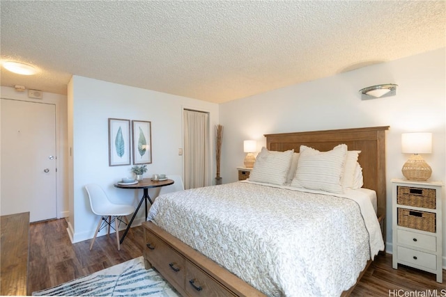 bedroom with a textured ceiling and dark hardwood / wood-style floors