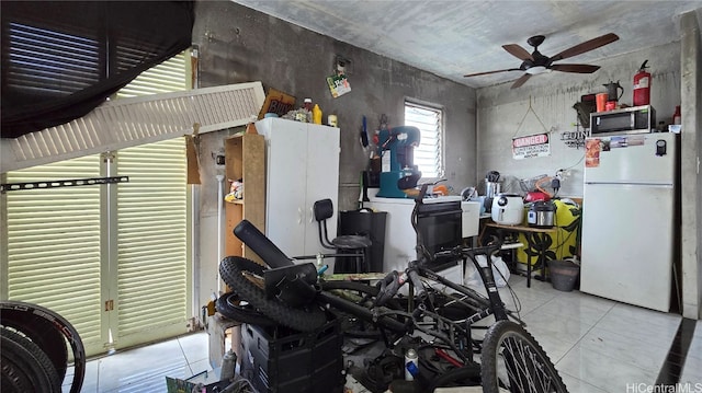 interior space featuring ceiling fan and white refrigerator