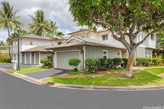 view of front of home with a front yard and a garage