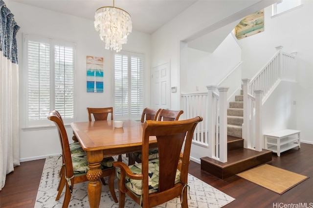 dining space featuring a notable chandelier and dark hardwood / wood-style flooring