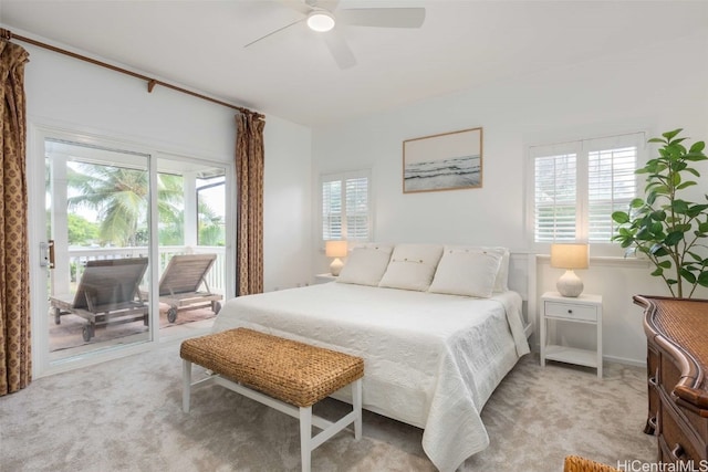 carpeted bedroom with multiple windows and ceiling fan