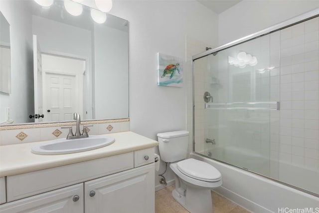 full bathroom featuring toilet, enclosed tub / shower combo, vanity, and tile patterned floors