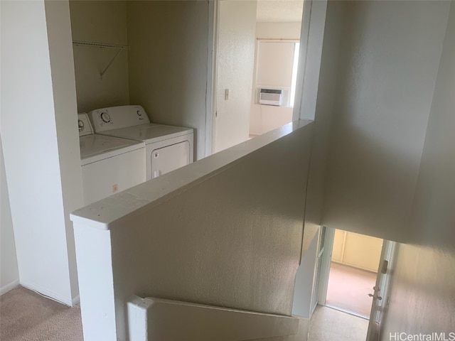 interior space featuring washer and clothes dryer and light colored carpet