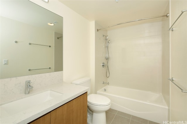 full bathroom featuring tiled shower / bath, vanity, toilet, and tile patterned flooring