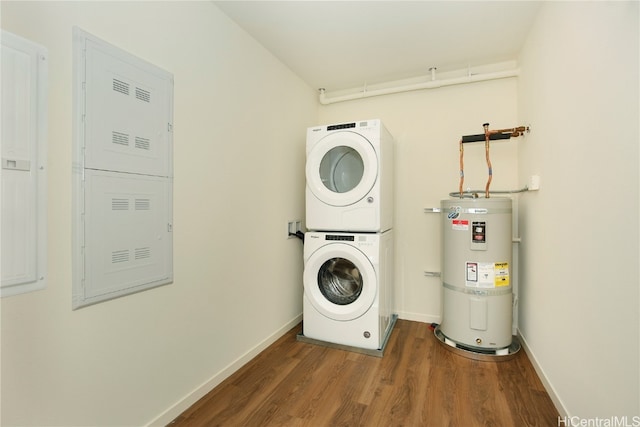 laundry area featuring water heater, stacked washer and dryer, and dark hardwood / wood-style flooring