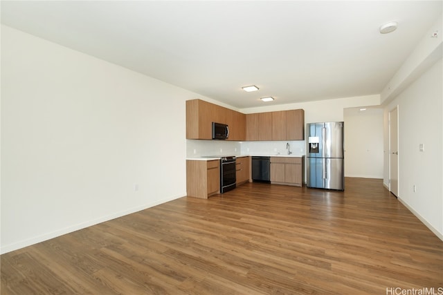 kitchen featuring sink, black appliances, and dark hardwood / wood-style flooring