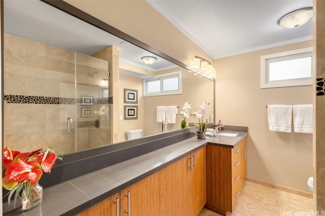 bathroom featuring toilet, tile patterned flooring, crown molding, vanity, and an enclosed shower