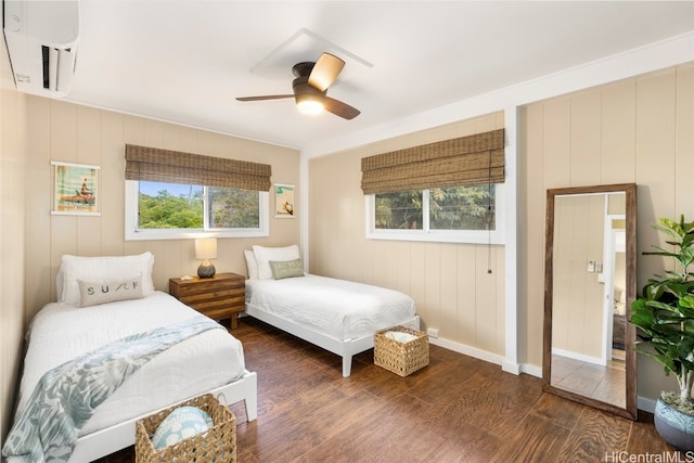 bedroom featuring multiple windows, dark hardwood / wood-style floors, and ceiling fan