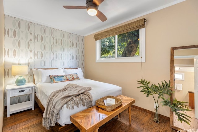 bedroom featuring crown molding, dark wood-type flooring, and ceiling fan