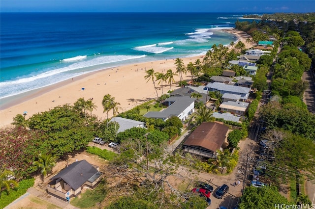 birds eye view of property with a water view and a view of the beach