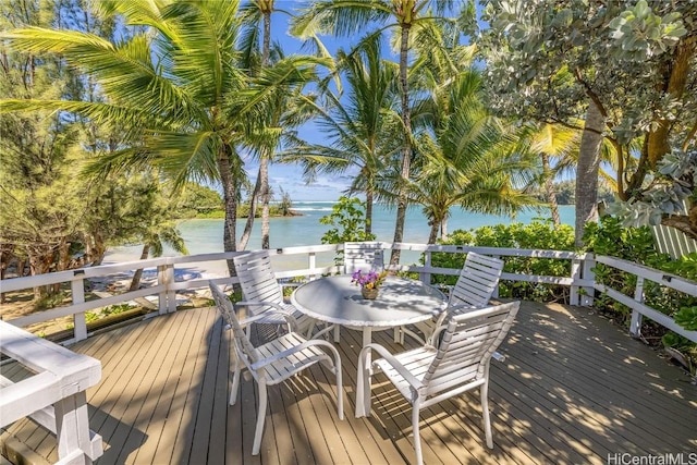 deck featuring a water view and outdoor dining area