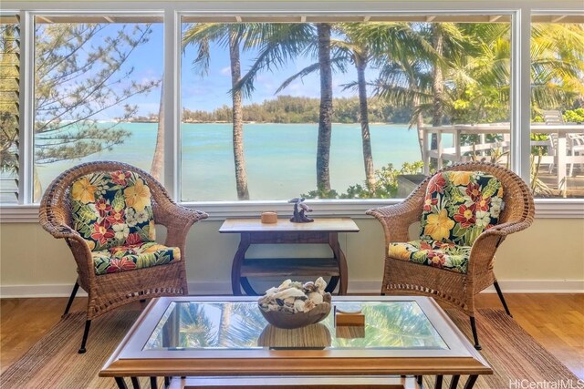 sunroom / solarium with a water view and a wealth of natural light