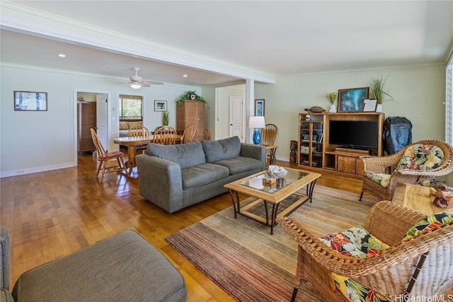 living area with recessed lighting, ornamental molding, a ceiling fan, wood finished floors, and baseboards