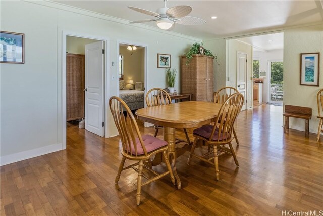 dining room with wood-type flooring, ceiling fan, and crown molding