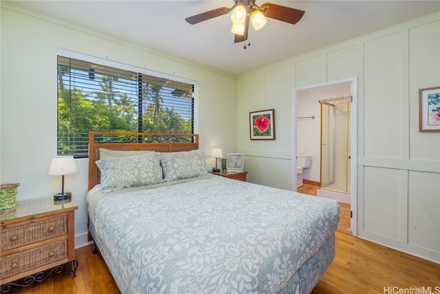 bedroom featuring connected bathroom, ornamental molding, light hardwood / wood-style floors, and ceiling fan