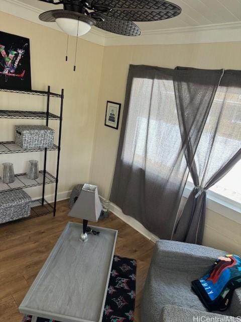 bedroom featuring a ceiling fan, baseboards, ornamental molding, and wood finished floors