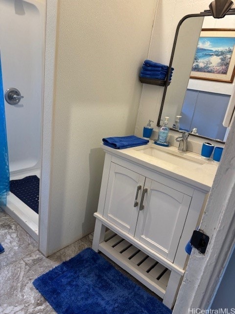 bathroom featuring vanity and a shower with shower curtain