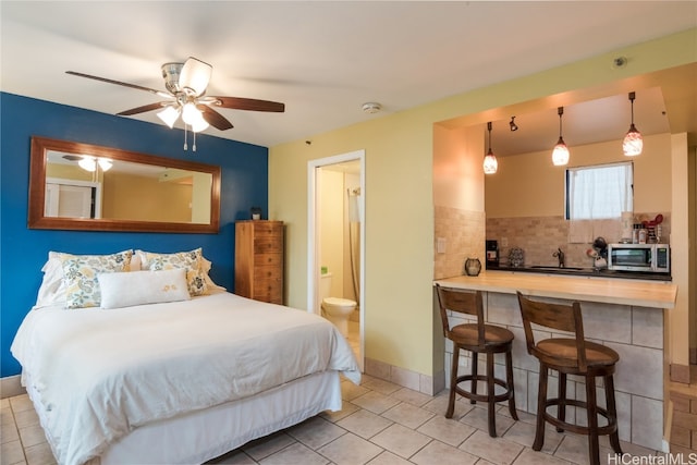 bedroom with connected bathroom, sink, and ceiling fan