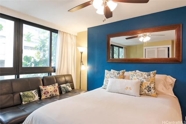 bedroom featuring multiple windows and ceiling fan