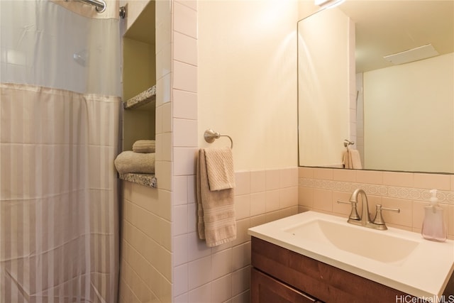 bathroom featuring vanity, tile walls, and a shower with curtain