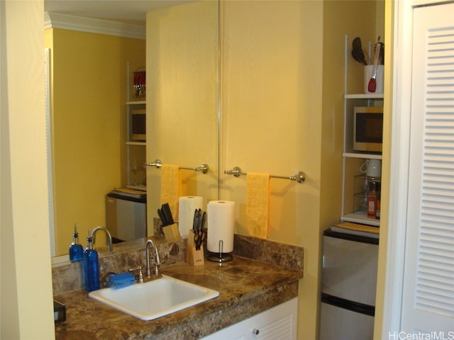 bathroom with vanity and ornamental molding