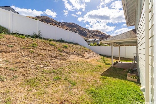 view of yard with a mountain view and a patio area