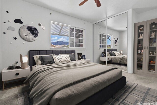 bedroom featuring carpet, a closet, and ceiling fan